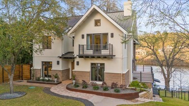 Rear view of house with stone siding, a chimney, 