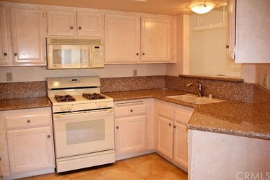 Terrific kitchen with granite counters and a pass 
