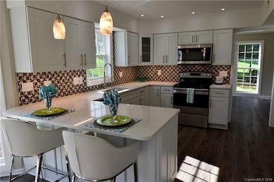 Large kitchen with eating bar and lots of lighting