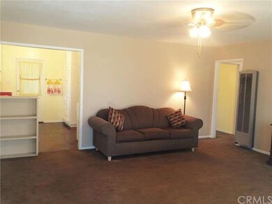 Spacious living room with ceiling fan which opens 