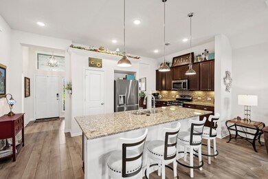 Entry way/ open concept kitchen with a granite isl