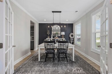 Dining space with crown molding, a chandelier, and