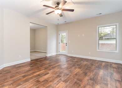 Beautiful flooring and and ceiling fan in this Jumbo Sized Family Room
