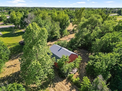 View from above of property featuring a heavily wooded area