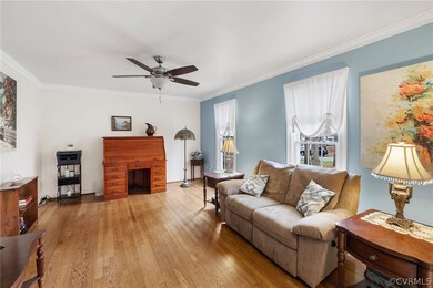 Large living room with hardwood floor, crown mould