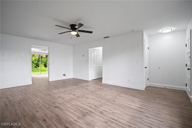 Unfurnished room featuring ceiling fan and wood fi