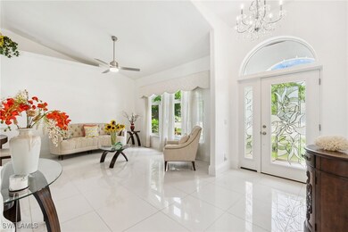 Entryway with a chandelier, light tile patterned f