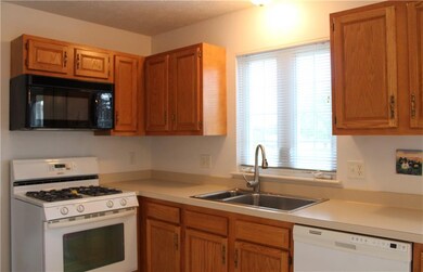 Honey oak cabinets, gas stove, microwave, dishwash