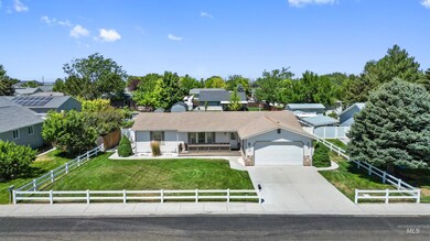 Ranch-style house featuring driveway, a garage, and a porch