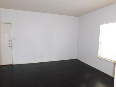 Unfurnished room with baseboards and dark wood-st