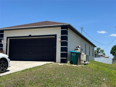 View of side of home with an attached garage, stuc