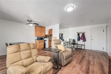 Living room featuring a textured ceiling, light ha