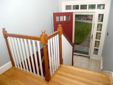 Entrance foyer & front door with transom lights.