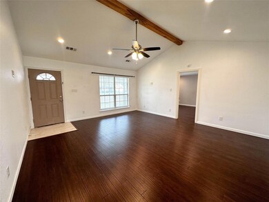Foyer entrance with lofted ceiling with beams, wood-type flooring, and ceiling fan