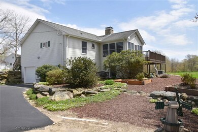 Back of house with garage and driveway