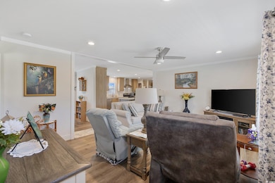 Living area with light wood-style flooring, a ceil