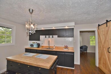 The kitchen features wood countertops and an islan