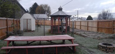 Fenced yard, gazebo, shed, flower beds