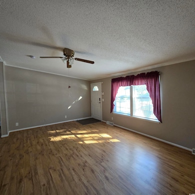 Unfurnished living room with a textured ceiling, d