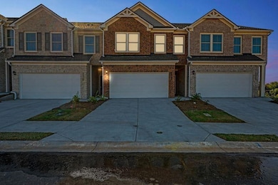 View of front facade featuring a garage