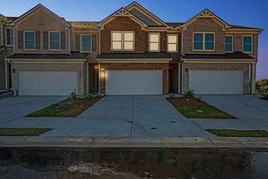 View of front facade featuring a garage