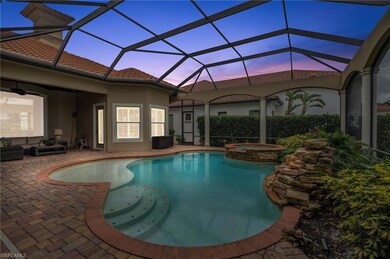 Pool at dusk featuring glass enclosure, a patio, a