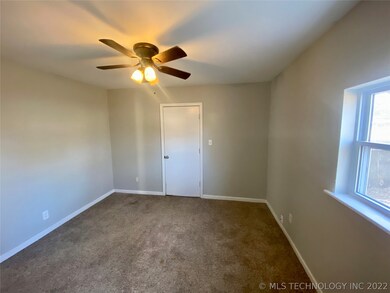 Primary bedroom with ceiling fan and natural light