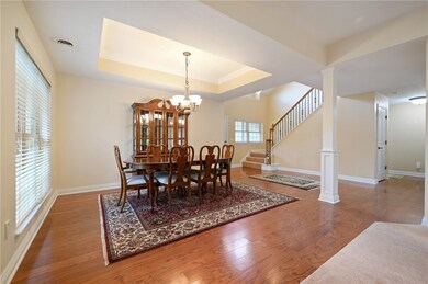 Dining room has double windows, a deep tray ceilin