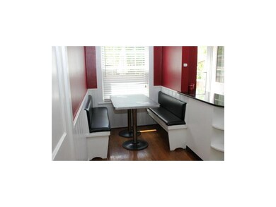 Kitchen has built-in benches for eating area.
