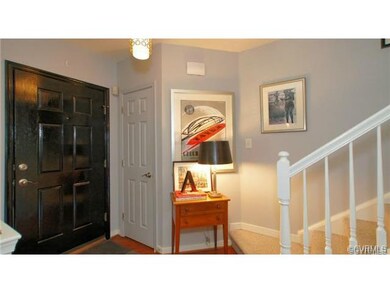 Foyer with coat closet, updated lighting and hardw