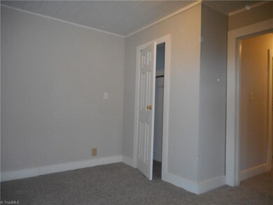 Primary Bedroom: Room features include carpet flooring, fresh paint, a window for natural lighting, and crown molding. You do loose some floor space due to the closet as shown in the picture. The main entry door is to the right side.