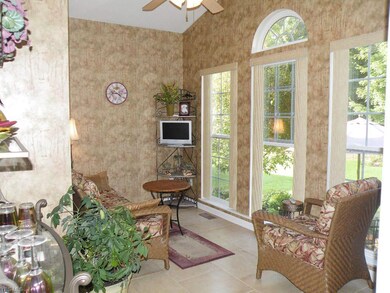 A comfortable sitting room overlooks the woods separating the back yard from the #3 green.