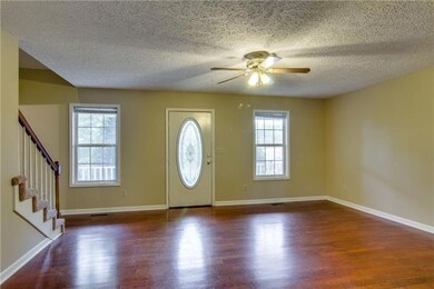 Spacious Living Room - notice the nice flooring and ceiling fan