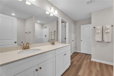 Bathroom featuring baseboards, wood finished floor