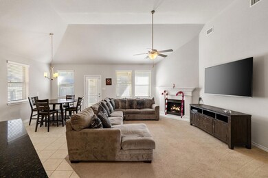 Living room with ceiling fan with notable chandeli
