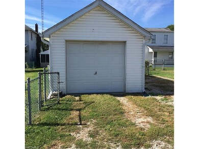 Garage with additional parking to the right side.