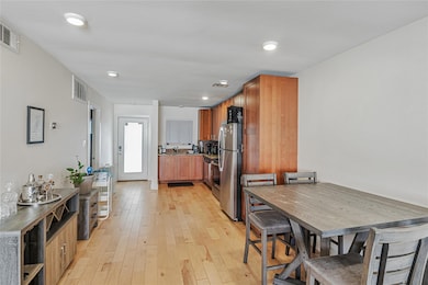 Dining space with light wood-style flooring and recessed lighting