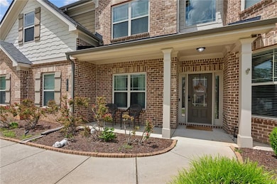 Property entrance with brick siding and a porch
