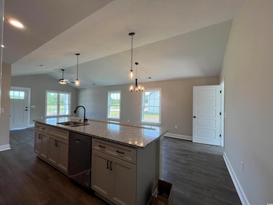 Kitchen featuring light stone countertops, a cente