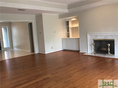 High ceiling and a wall of glass give this living 