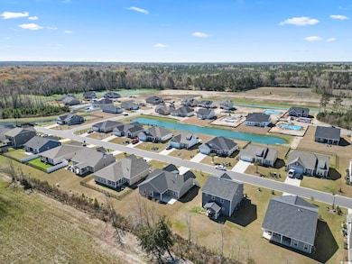 Birds eye view of property featuring a forest view and a residential view
