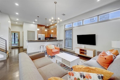 Living room with concrete floors, recessed lighti