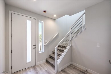 Foyer entrance featuring stairway, plenty of natural light, light wood-type flooring, and recessed lighting