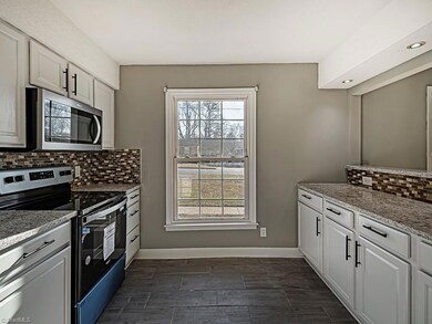 Kitchen with views of backyard