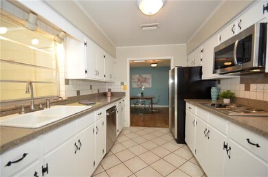 Large galley kitchen with ample cabinets and count