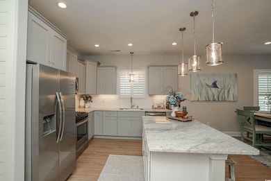 Kitchen featuring a center island, a sink, recesse