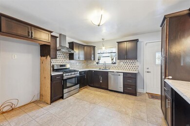 Spacious Kitchen with stainless steel appliances, custom cabinetry, pantry, desk and ceramic tile flooring