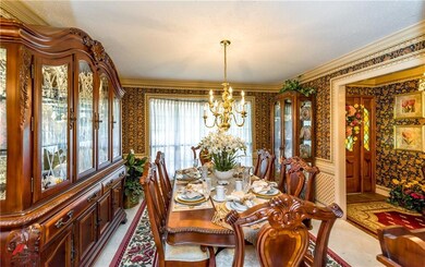 Formal dining room has detailed crown moldings and