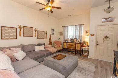 Living room with visible vents, light wood-style f