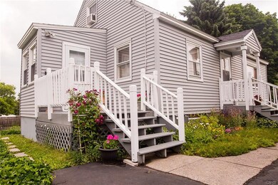 Side view of the home with side stairs into the mu